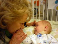 A mother kisses her child in the Transitional Care Center.